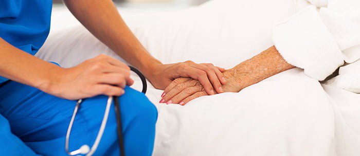 nurse holding patient's hand