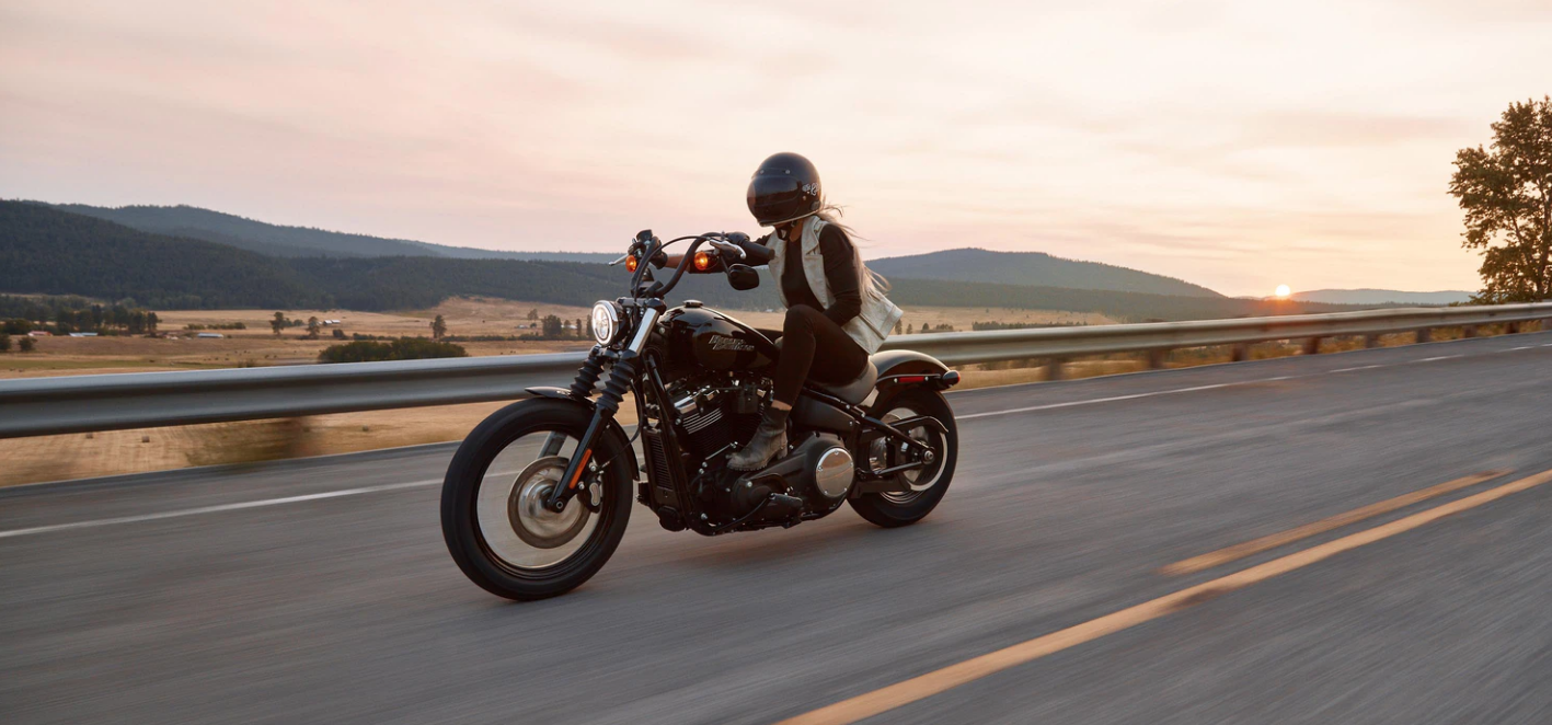 person riding black cruiser motorcycle